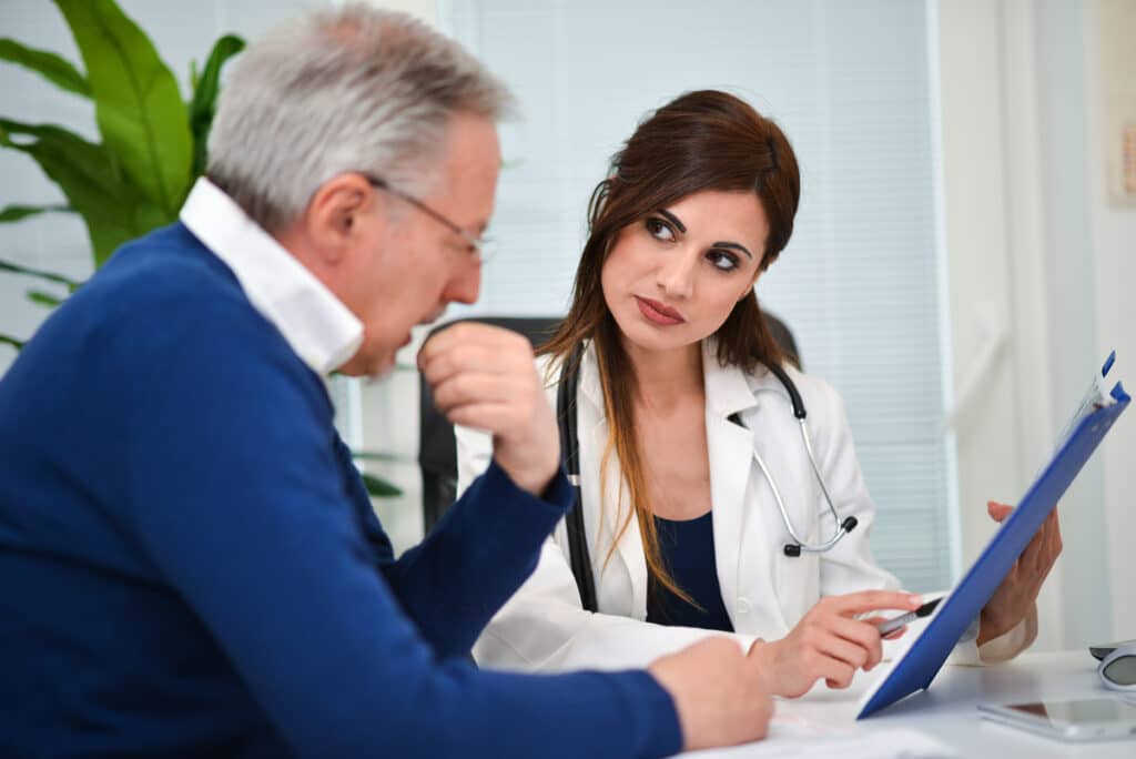 Older man consulting with a doctor to understand andropause vs low testosterone and his treatment options